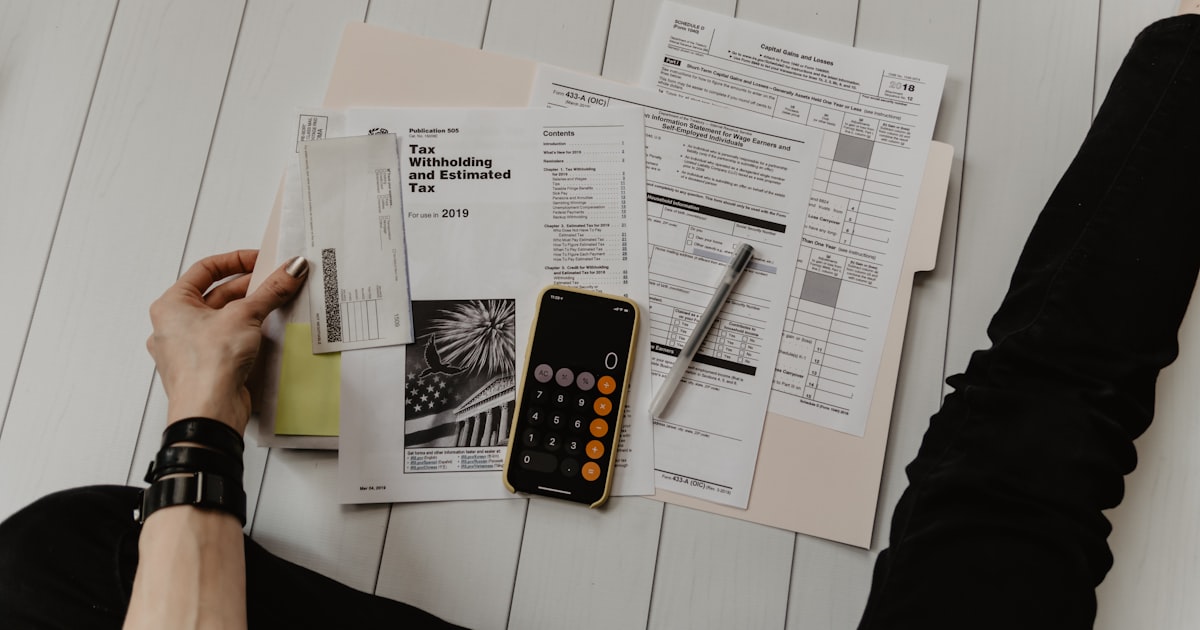Person reviewing credit report documents at desk
